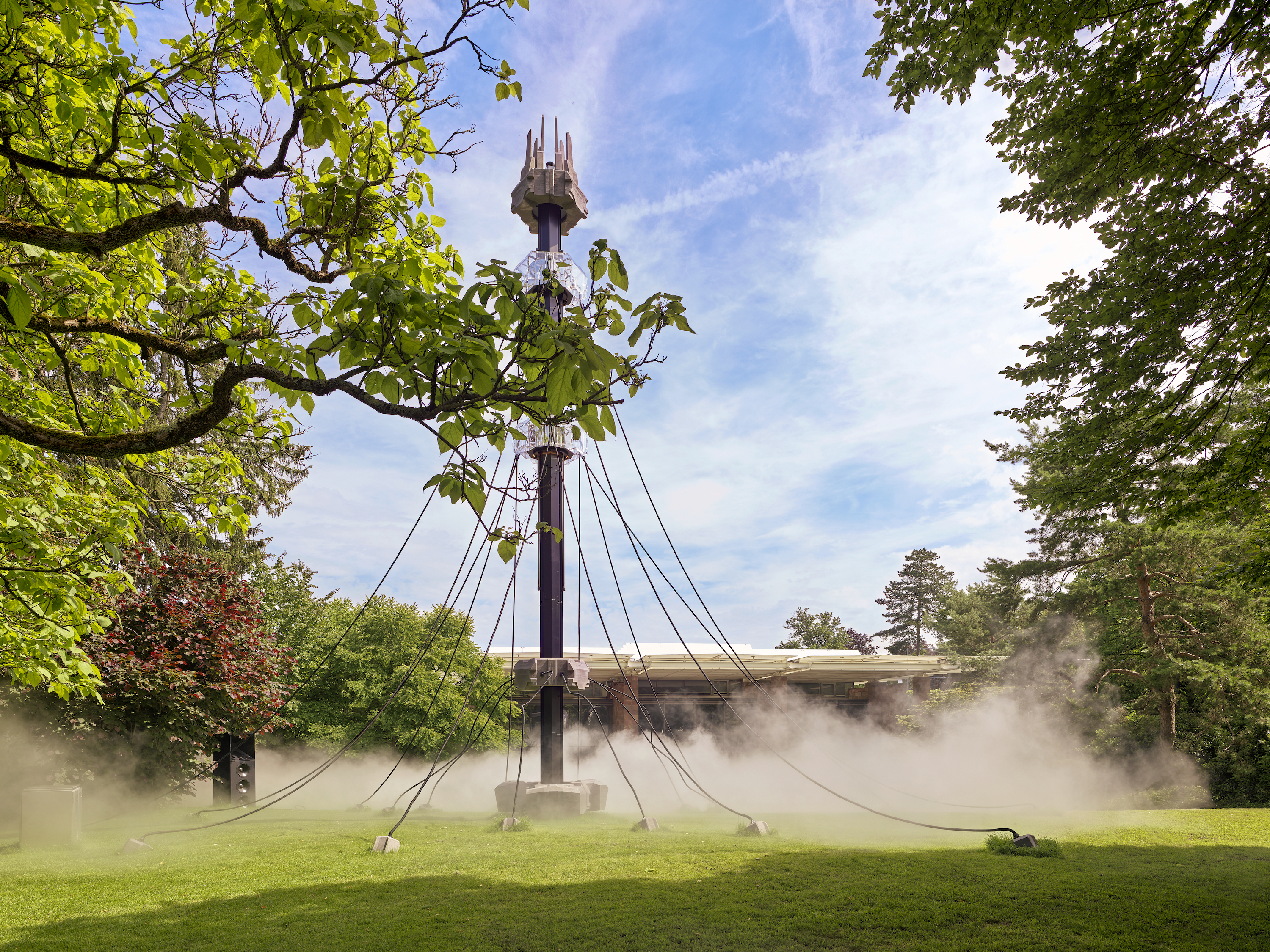 Fondation Beyeler - a large pole with steam below it in a garden