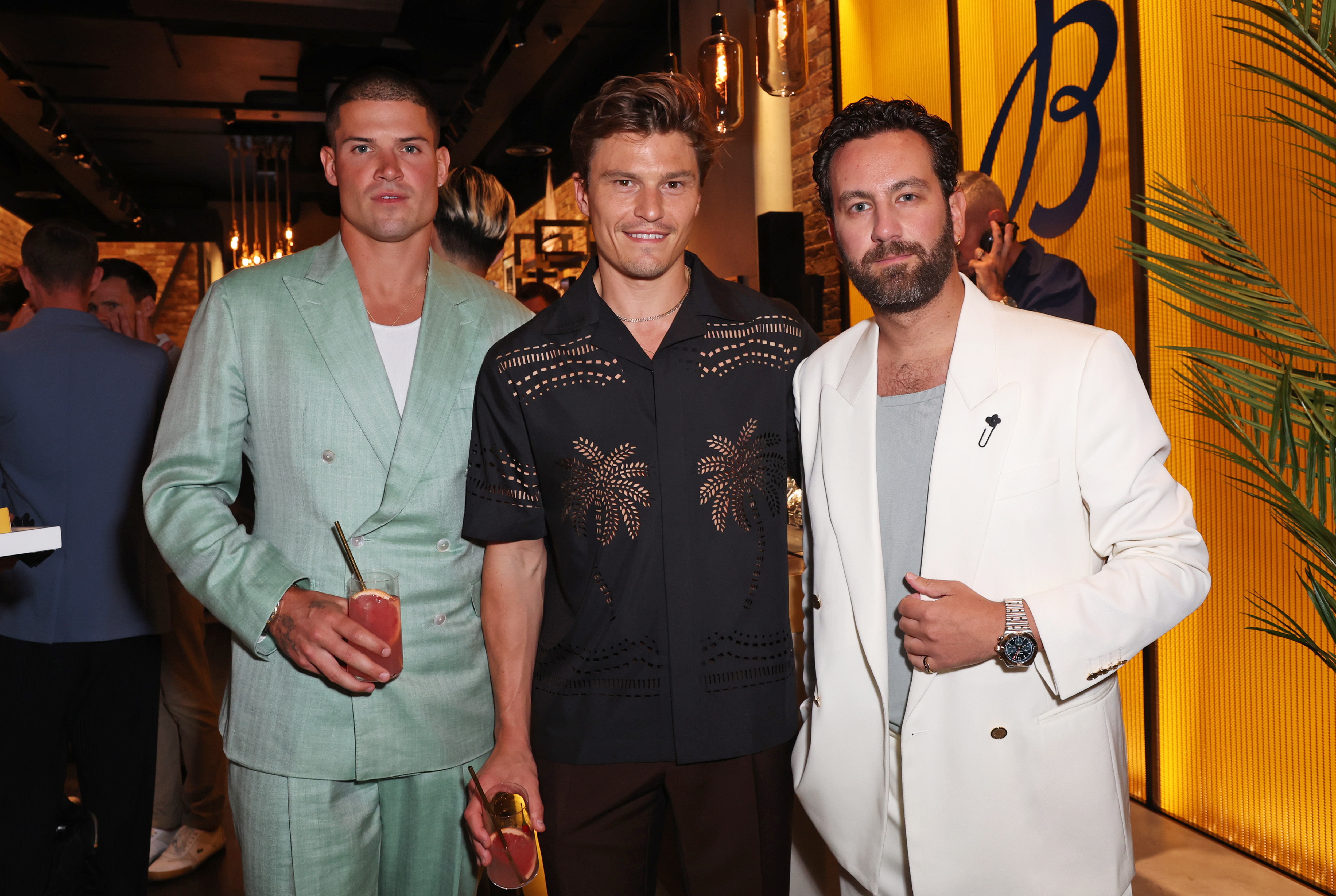 Breitling - three men, one wearing turquoise, one in black and the other in white 