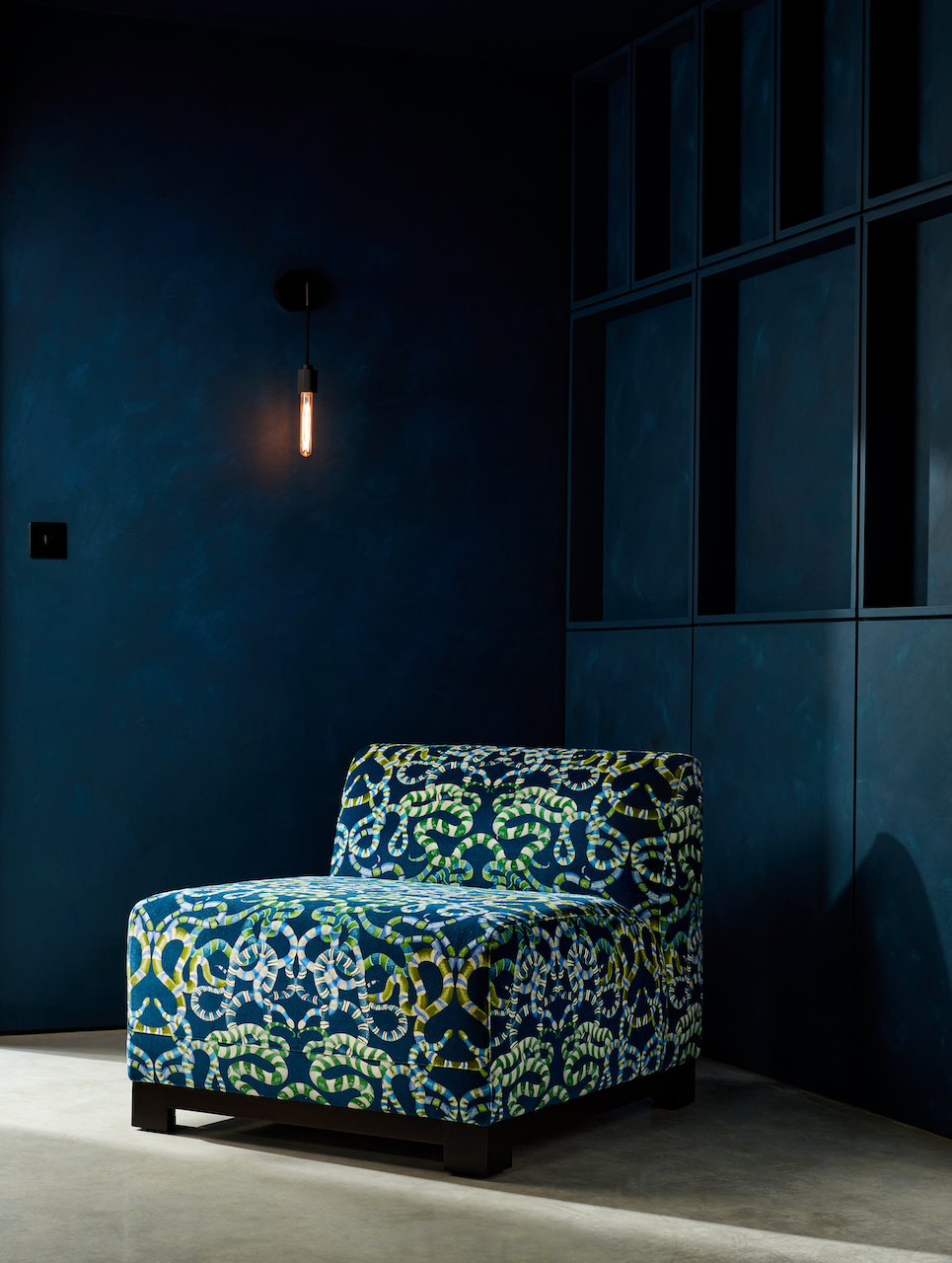 Luxury Chinese New Year of the Snake - sanderson snake patterned chair in the corner of a blue room