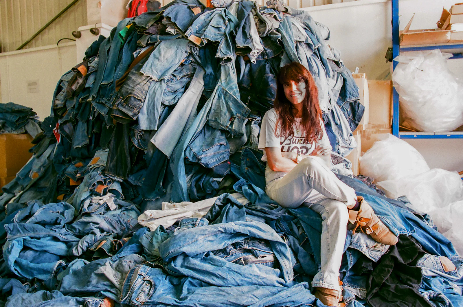 Walpole Brands of Tomorrow 2025 - Anna Foster sat on a pile of blue denim jeans