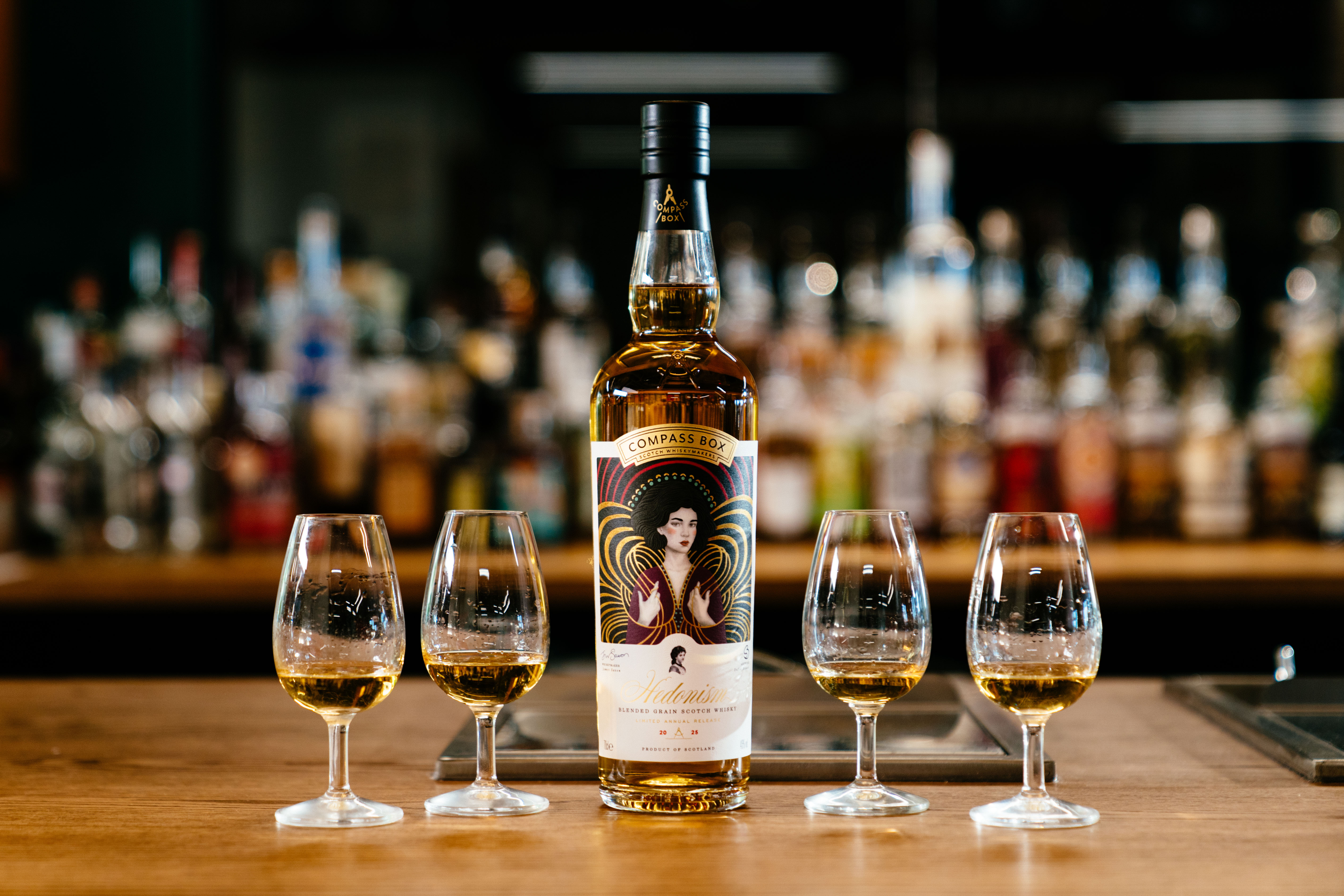 Compass Box Hedonism 2025 - a bottle of the Hedonism 2025 Release with four tasting glasses