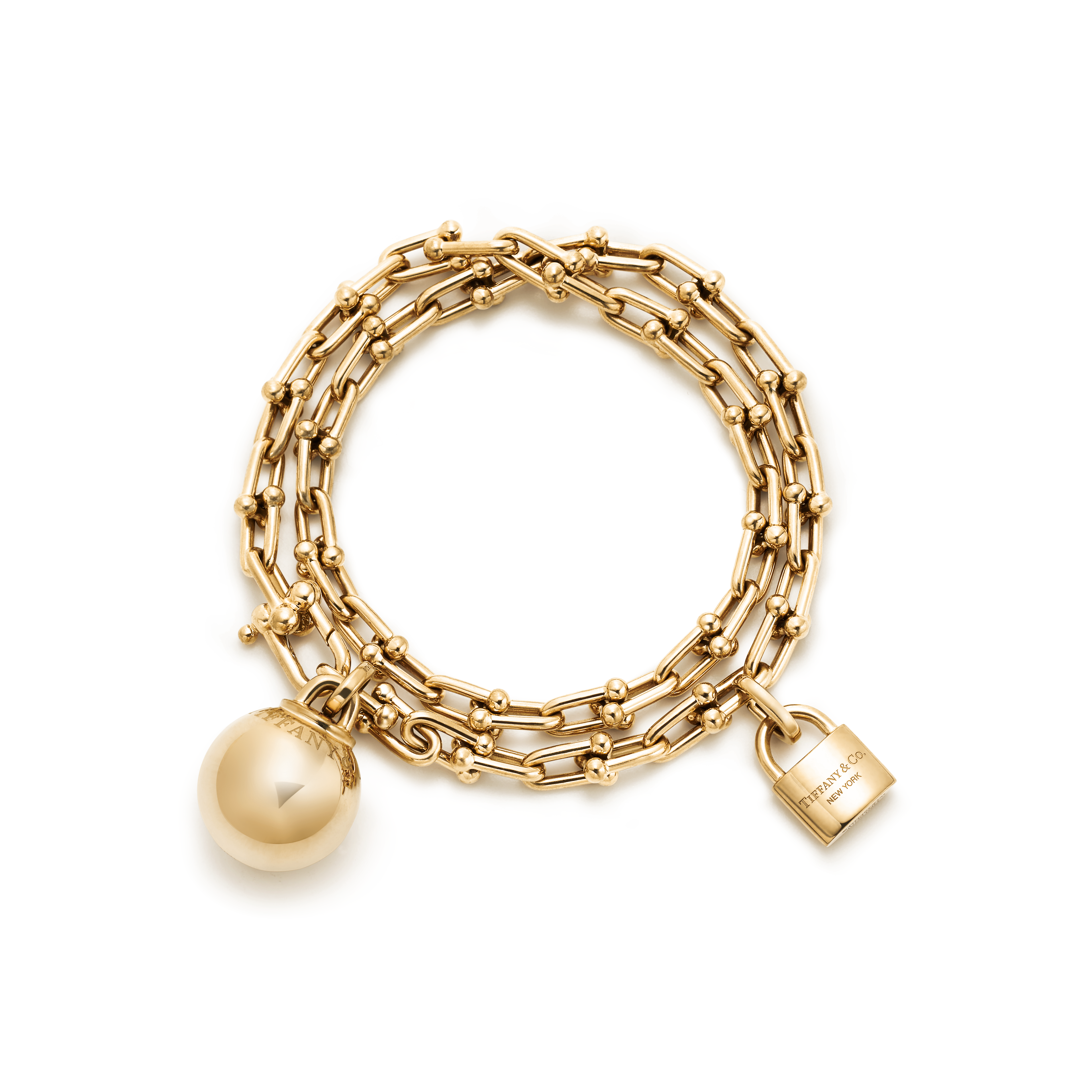 Bracelet Stacks - gold chain link bracelet with two chains and a Tiffany & Co padlock and a gold ball