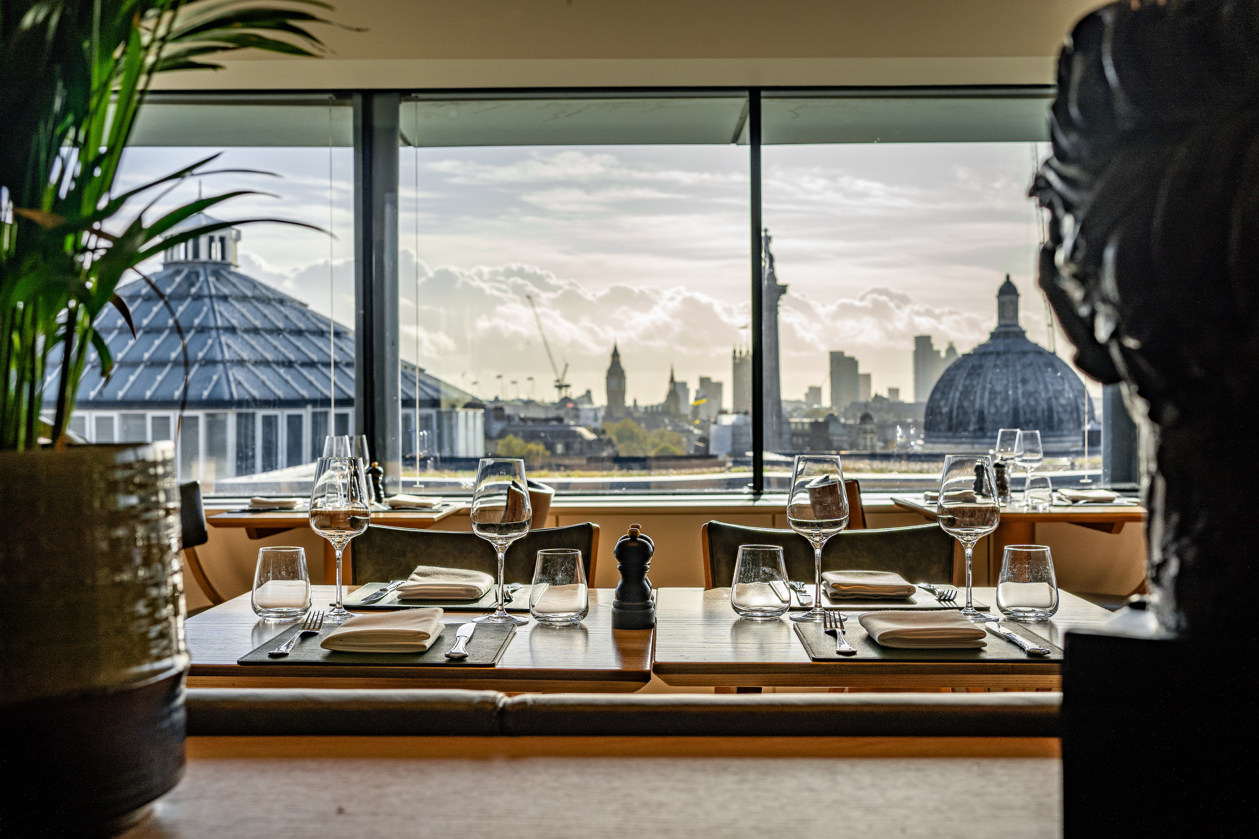 Art restaurants in London - A beautifully set restaurant table in The Portrait Restaurant found in the National Portrait Gallery overlooking a panoramic view of London's skyline.