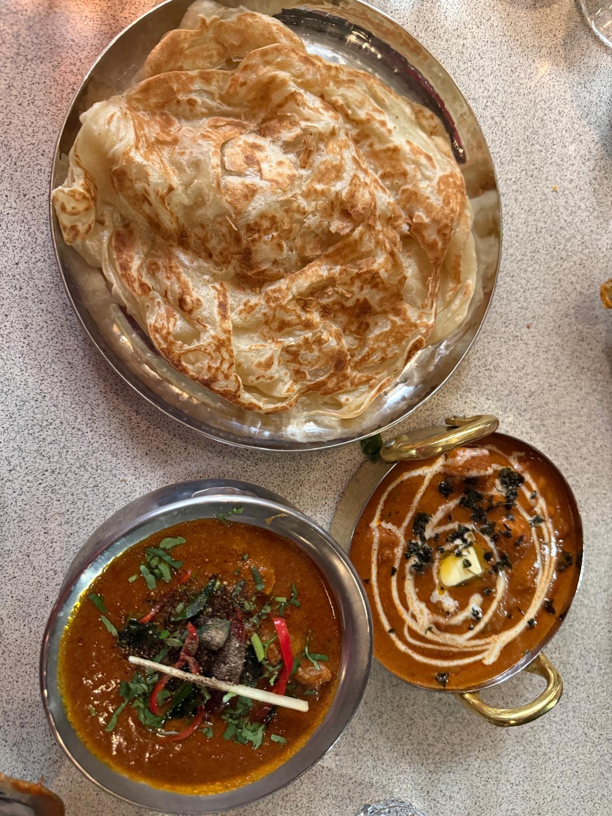 Tamila Restaurant Kings Cross - naan bread in dish alongside two curries in silver dishes