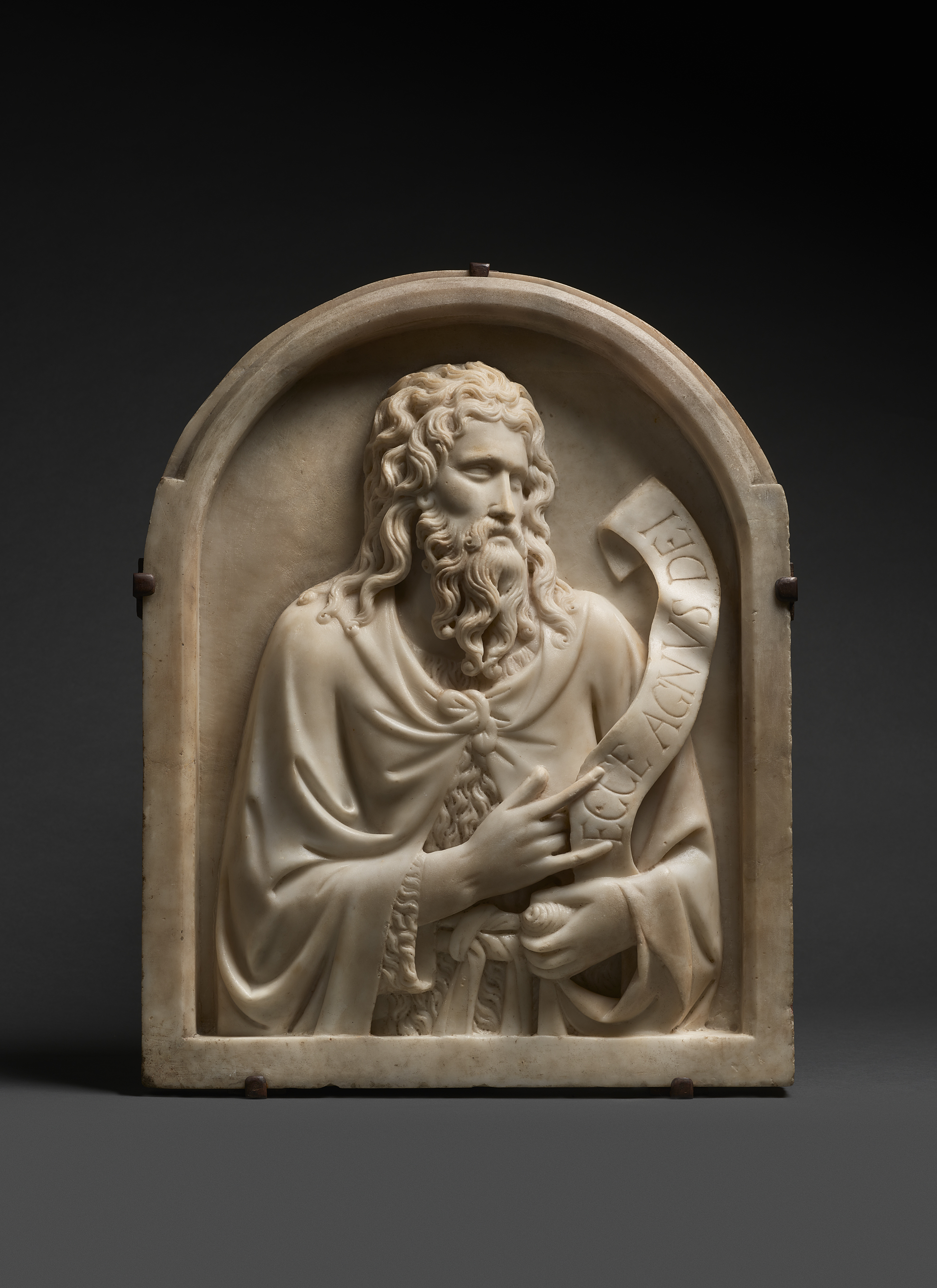 Siena at The National Gallery - St John the Baptist by Tino da Camaino is a marble sculpture of John the Baptist, depicted with a flowing beard and draped robes, holding a scroll inscribed Ecce Agnus Dei.