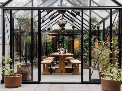 Exeter hotel - a glass room with plants and a table